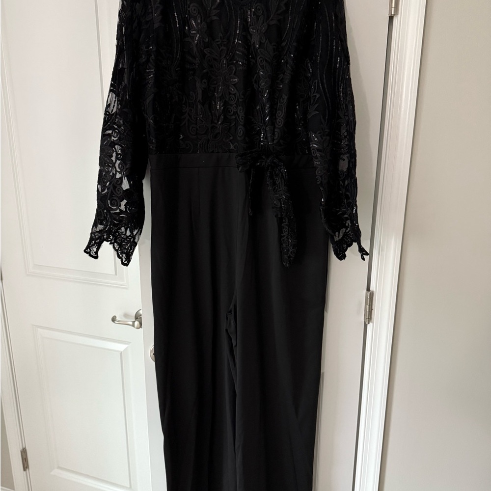 Black pant suit with sequined and lace top. Brand new.